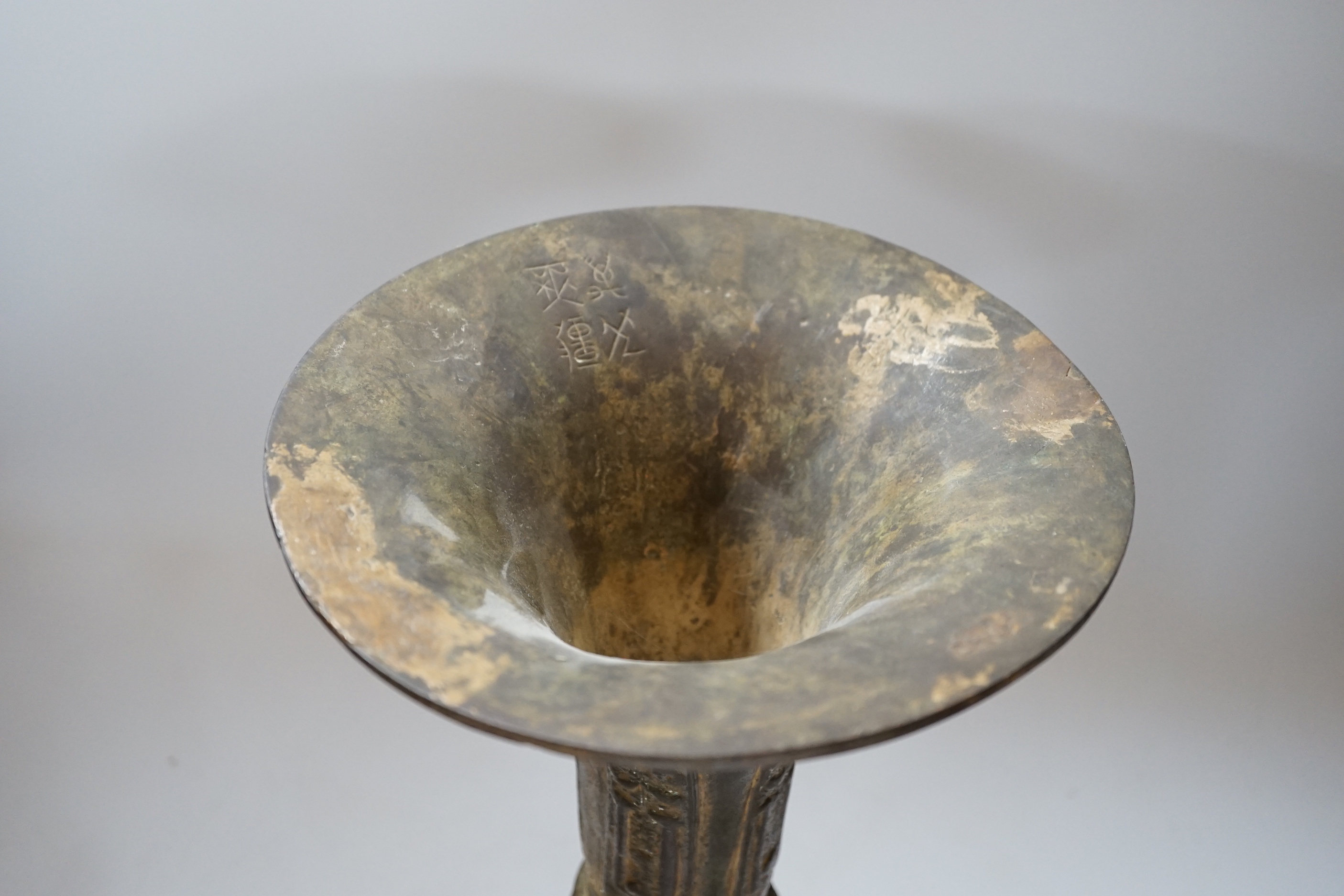 A Chinese bronze gu vase, a 19th century Chinese blue and white vase and a Tibetan teapot, tallest 34cm